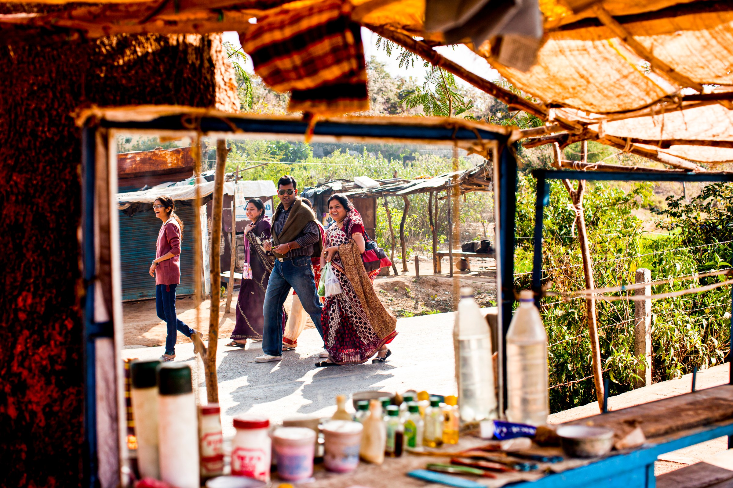 An Indian family walk by a barber shop in Orchha, Madhya Pradesh, India, on February 1, 2012.