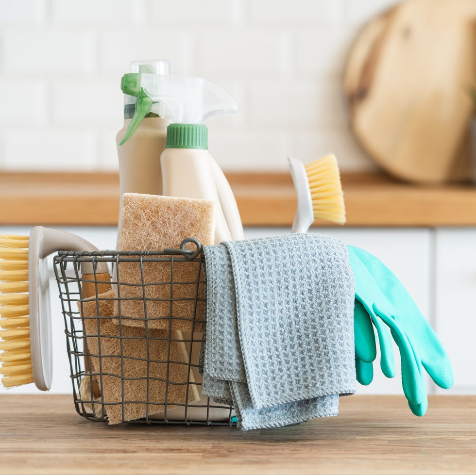 basket with brushes, rags, natural sponges and cleaning products