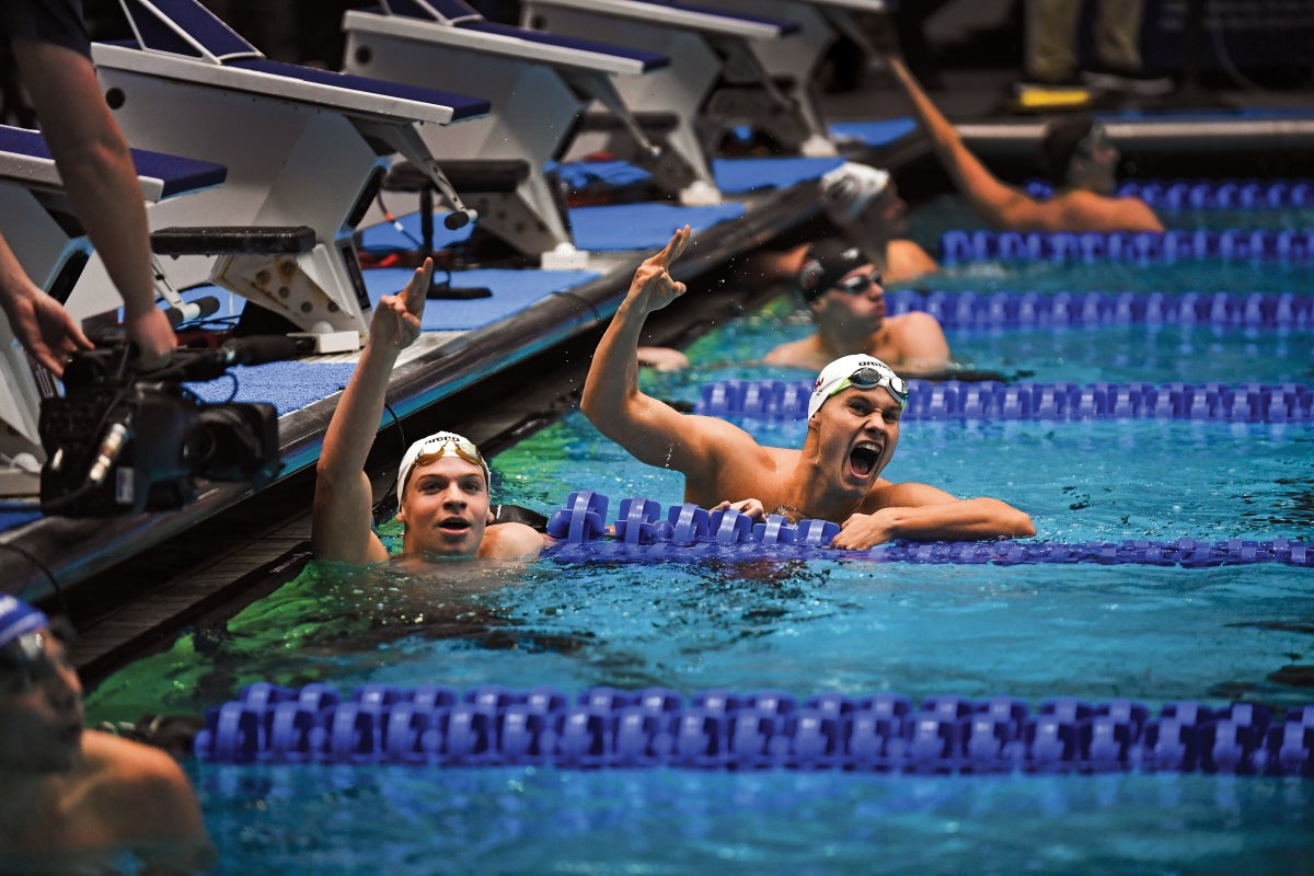 Olympic swimmers cheering in the pool