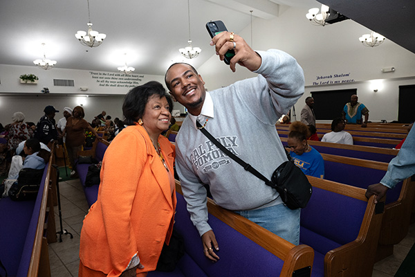 President Coley and parishioner take a selfie.